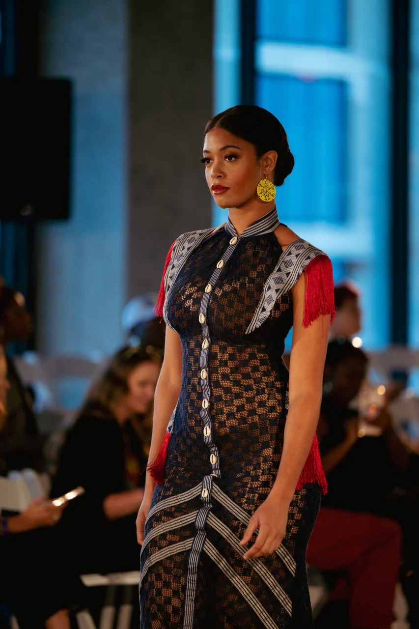 Podium — robe dentelle marine, franges rouges et boutons cauris